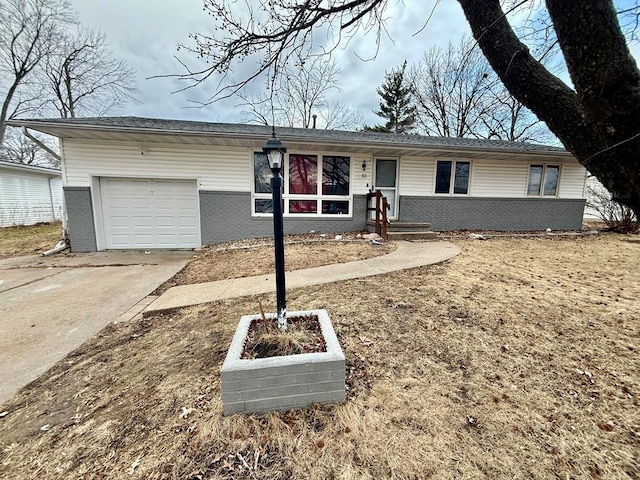 ranch-style home with driveway, brick siding, and an attached garage