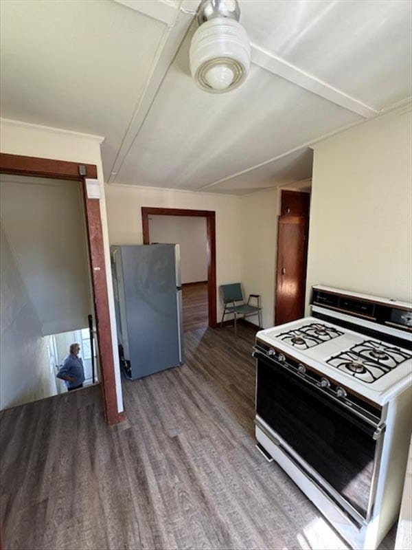 kitchen featuring stainless steel refrigerator, hardwood / wood-style floors, and white range