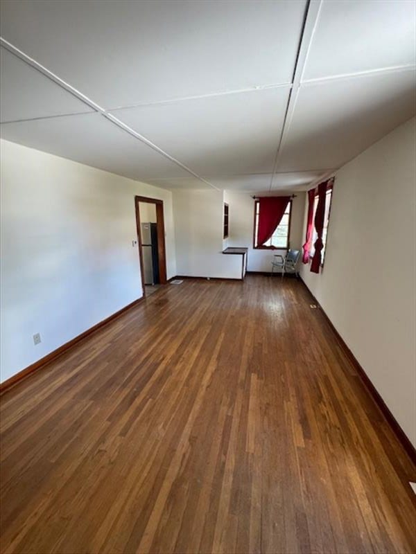 empty room with dark wood-type flooring