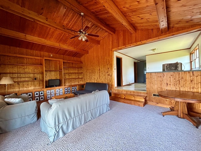 carpeted bedroom featuring lofted ceiling with beams, wooden walls, and wooden ceiling