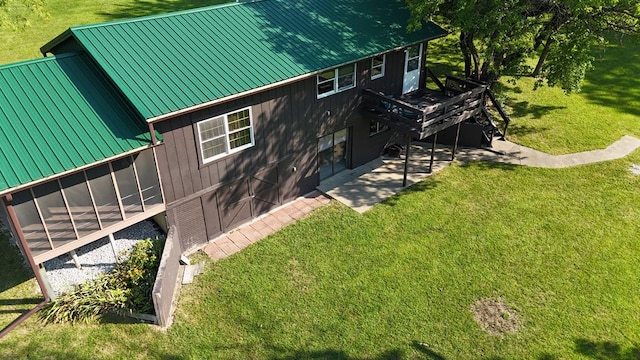 exterior space featuring a lawn and a sunroom