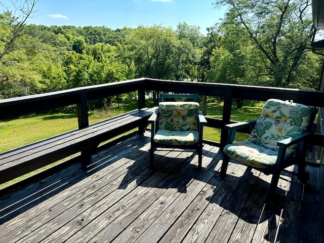 wooden deck featuring a lawn