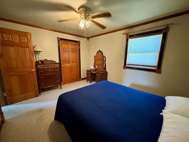 carpeted bedroom with ceiling fan and crown molding