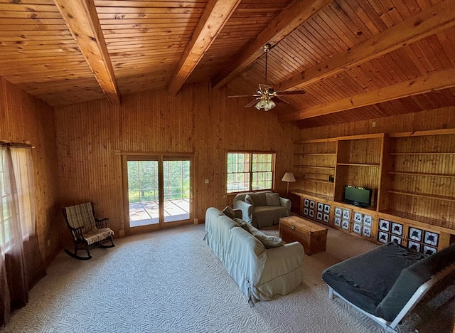 living room with ceiling fan, wooden ceiling, vaulted ceiling with beams, wood walls, and carpet floors