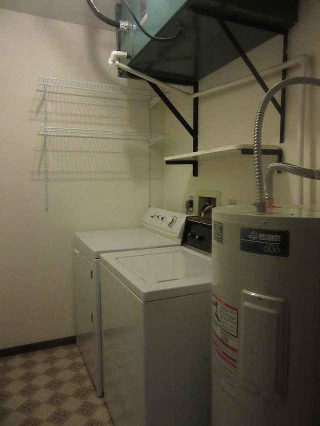 laundry area with separate washer and dryer and water heater