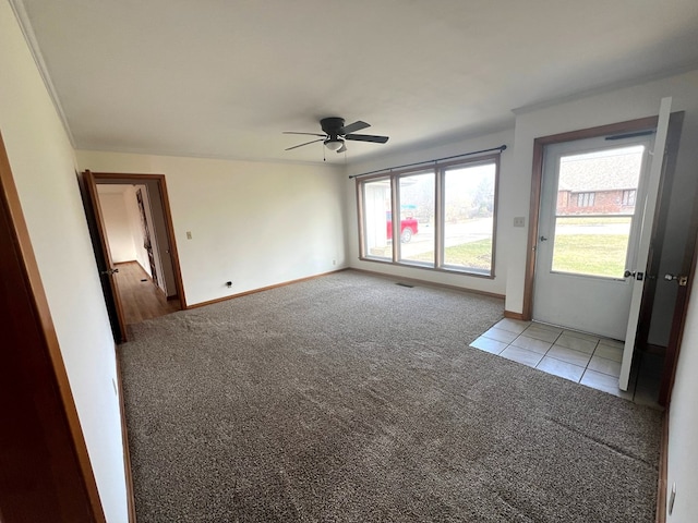 carpeted empty room featuring ceiling fan