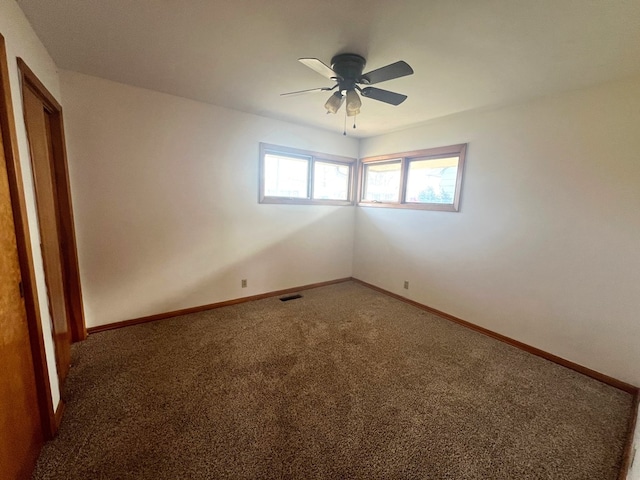 carpeted empty room featuring ceiling fan