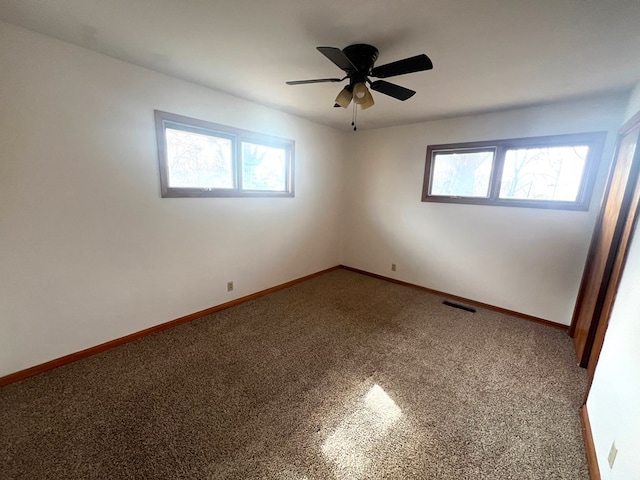 empty room with carpet flooring and ceiling fan