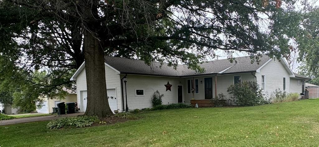 single story home with a front yard and a garage