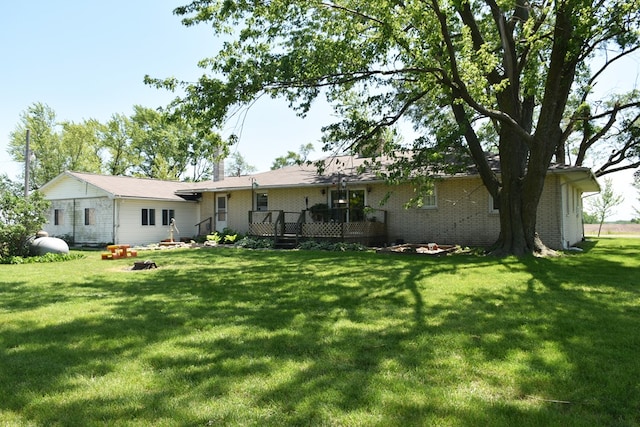 back of property with a yard and a deck