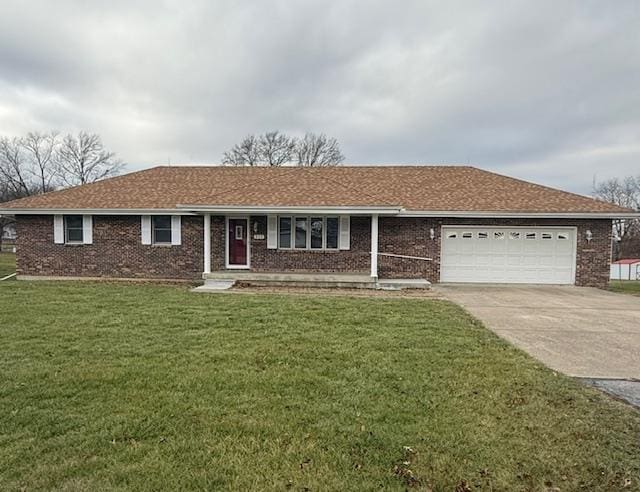 ranch-style house featuring a front yard and a garage