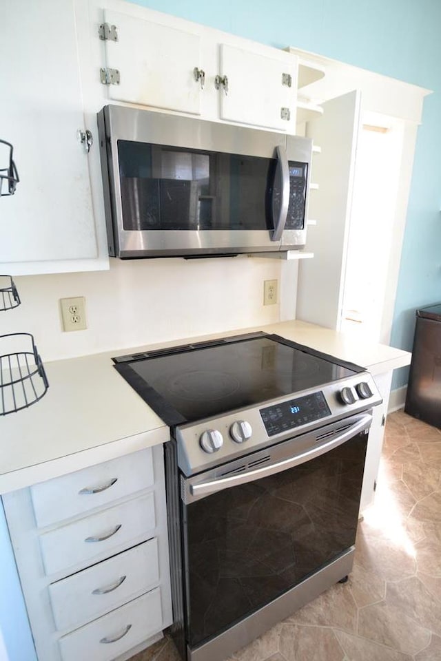 kitchen featuring white cabinets and appliances with stainless steel finishes