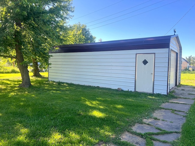 view of outbuilding with a yard