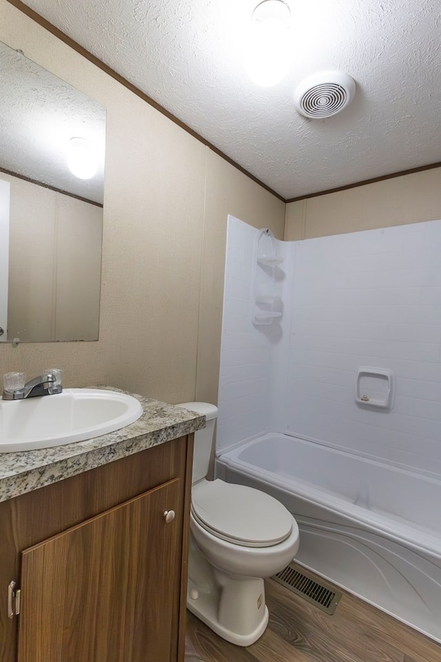 1018 Logue Ln, Keytesville, MO 65261 - full bathroom with vanity, visible vents, a textured ceiling, and wood finished floors