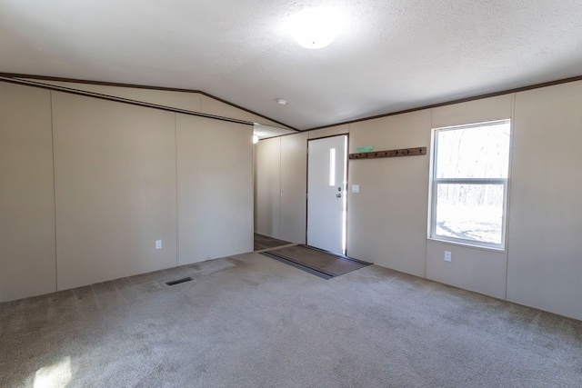 1018 Logue Ln, Keytesville, MO 65261 - carpeted spare room with visible vents, a textured ceiling, and lofted ceiling
