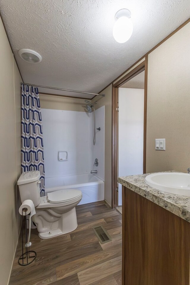 1018 Logue Ln, Keytesville, MO 65261 - bathroom featuring visible vents, toilet, wood finished floors, and a textured ceiling