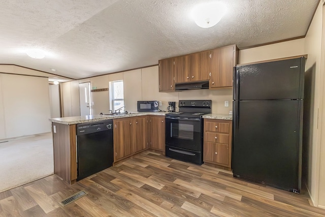 1018 Logue Ln, Keytesville, MO 65261 - kitchen featuring brown cabinets, visible vents, black appliances, and under cabinet range hood