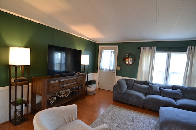 49615 Peach Rd, Milan, MO 63556 - living room featuring a decorative wall, vaulted ceiling, wood finished floors, wainscoting, and crown molding