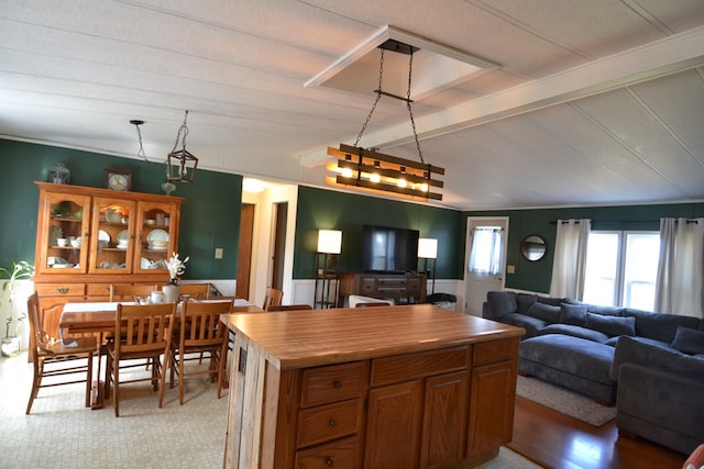 49615 Peach Rd, Milan, MO 63556 - kitchen with open floor plan, a wainscoted wall, a kitchen island, wood counters, and brown cabinets