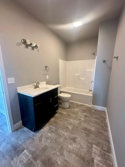 full bathroom featuring toilet, hardwood / wood-style flooring, bathing tub / shower combination, and vanity