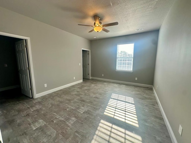 unfurnished bedroom with a textured ceiling, ceiling fan, and wood-type flooring