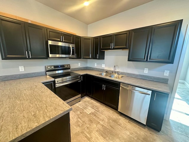 kitchen featuring sink, light wood-type flooring, and stainless steel appliances