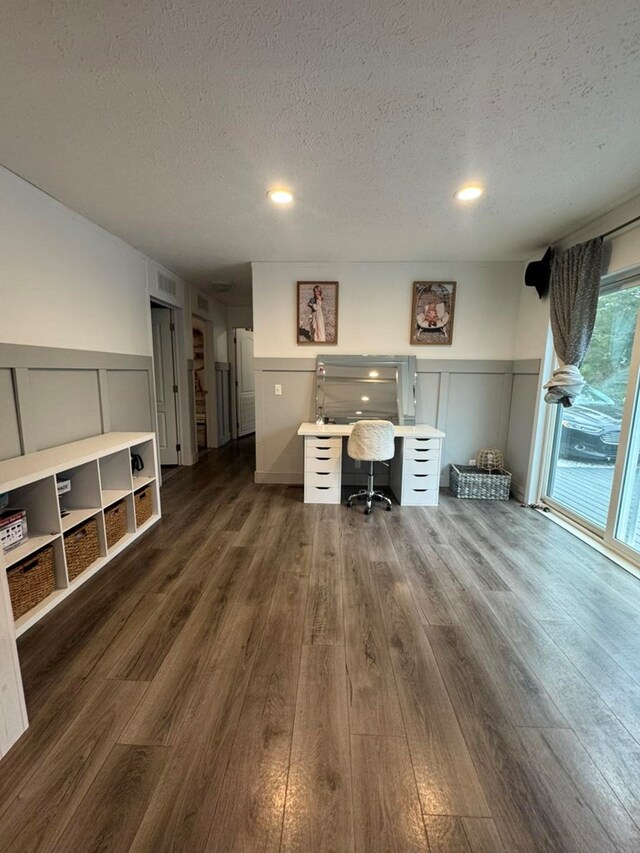 501 SE State St, Milan, MO 63556 - office area with a textured ceiling, a decorative wall, and dark wood-style floors