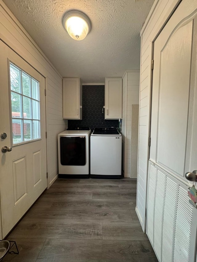 501 SE State St, Milan, MO 63556 - washroom with a textured ceiling, dark wood-style floors, cabinet space, and washer and clothes dryer
