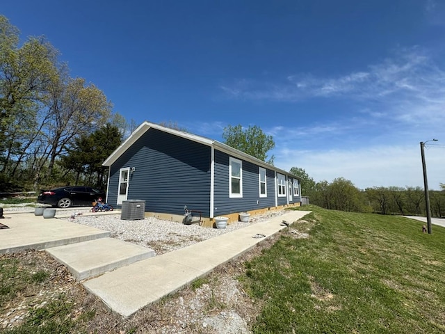 501 SE State St, Milan, MO 63556 - view of home's exterior with a lawn and central AC