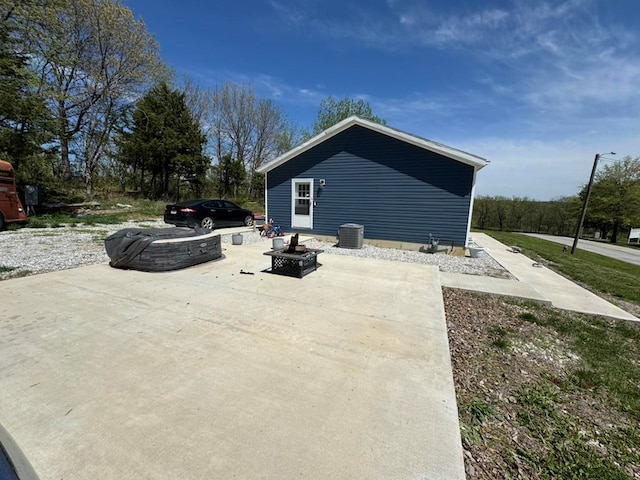 501 SE State St, Milan, MO 63556 - view of home's exterior with a fire pit and central AC