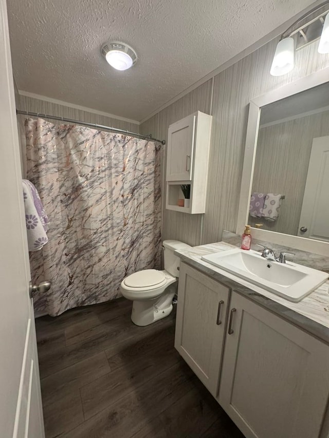 501 SE State St, Milan, MO 63556 - bathroom featuring vanity, crown molding, wood finished floors, toilet, and a textured ceiling