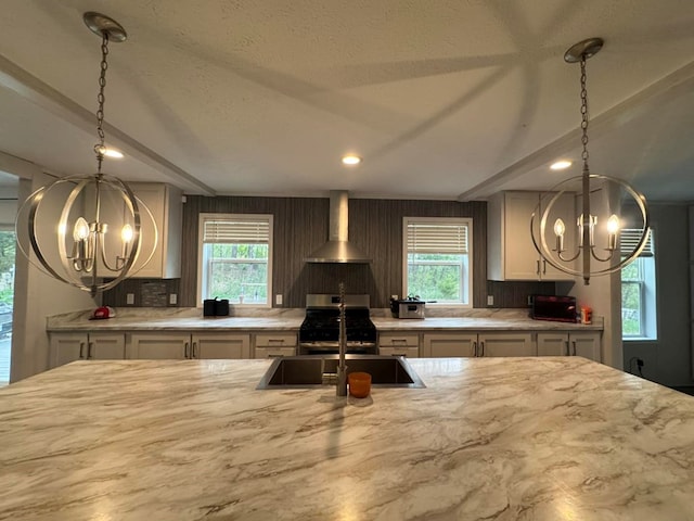 501 SE State St, Milan, MO 63556 - kitchen with a sink, gas range, wall chimney exhaust hood, and a chandelier