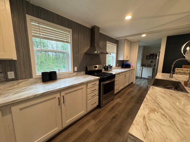 501 SE State St, Milan, MO 63556 - kitchen featuring white cabinets, a sink, wall chimney exhaust hood, and stainless steel gas stove
