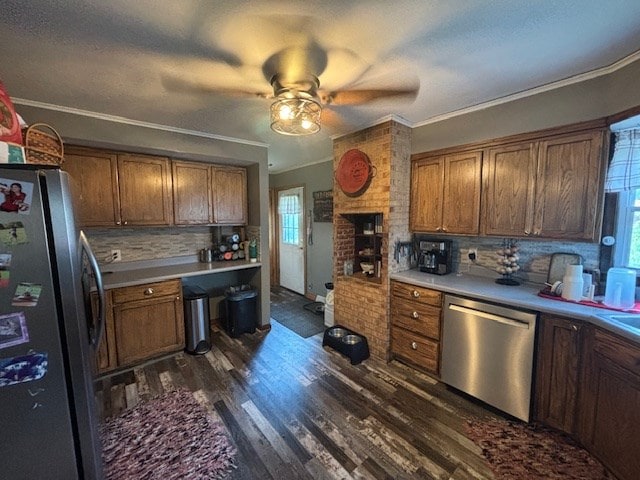 1715 E Mcpherson St, Kirksville, MO 63501 - kitchen featuring built in study area, decorative backsplash, ceiling fan, dark wood finished floors, and appliances with stainless steel finishes