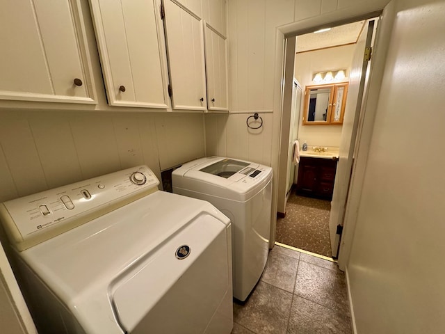 laundry area featuring washer and clothes dryer and cabinet space