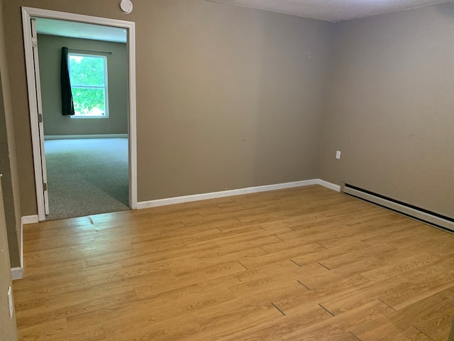 615 N Elson St, Kirksville, MO 63501 - empty room with light wood-style floors and baseboard heating