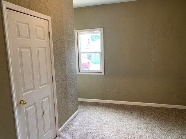 615 N Elson St, Kirksville, MO 63501 - spare room featuring carpet floors and a textured wall