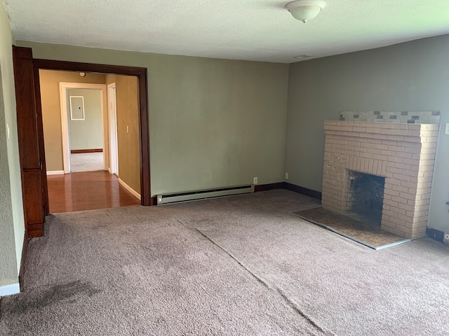 615 N Elson St, Kirksville, MO 63501 - unfurnished living room featuring a baseboard heating unit, carpet, a brick fireplace, and a textured ceiling
