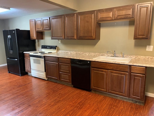 615 N Elson St, Kirksville, MO 63501 - kitchen featuring black appliances, light countertops, and dark wood finished floors