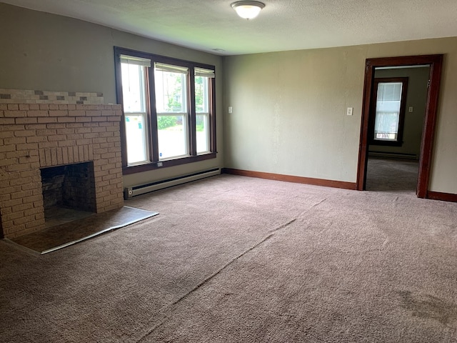 615 N Elson St, Kirksville, MO 63501 - unfurnished living room featuring baseboard heating, carpet floors, a brick fireplace, a textured ceiling, and a baseboard heating unit
