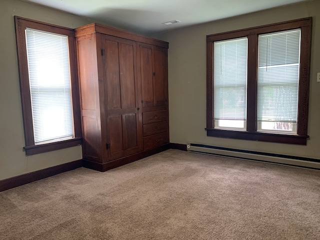 615 N Elson St, Kirksville, MO 63501 - unfurnished bedroom with a baseboard radiator, light carpet, and a closet