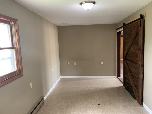 615 N Elson St, Kirksville, MO 63501 - unfurnished room featuring a barn door, tile patterned floors, and baseboard heating