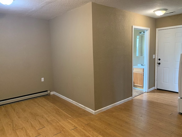 615 N Elson St, Kirksville, MO 63501 - foyer with a textured ceiling, light wood finished floors, and a baseboard radiator