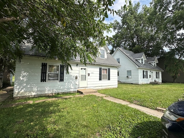 new england style home with a front lawn