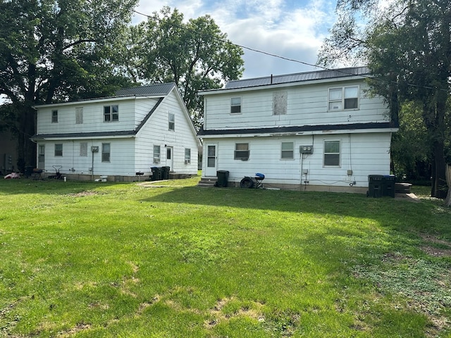 back of house with a lawn