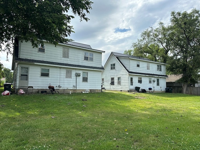 back of property featuring a lawn