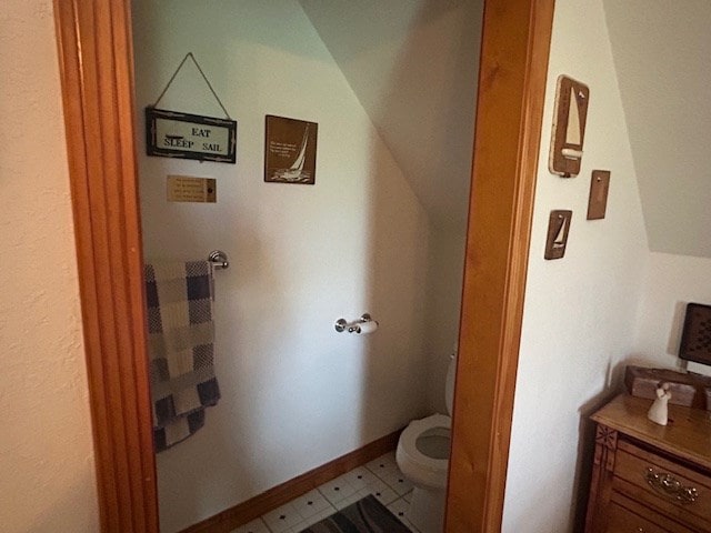 bathroom featuring vaulted ceiling and toilet