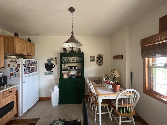 dining space featuring light tile patterned floors