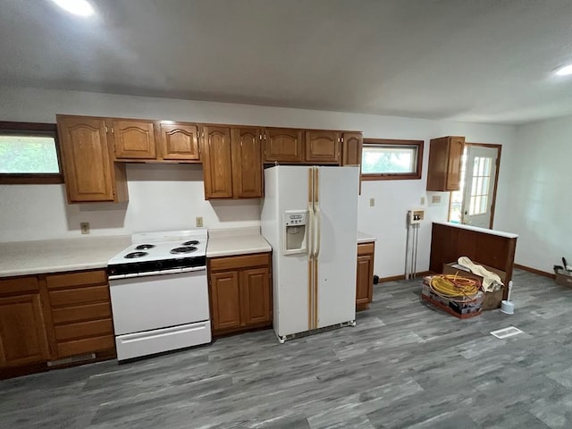 kitchen featuring wood-type flooring and white appliances