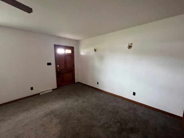 foyer entrance with dark colored carpet